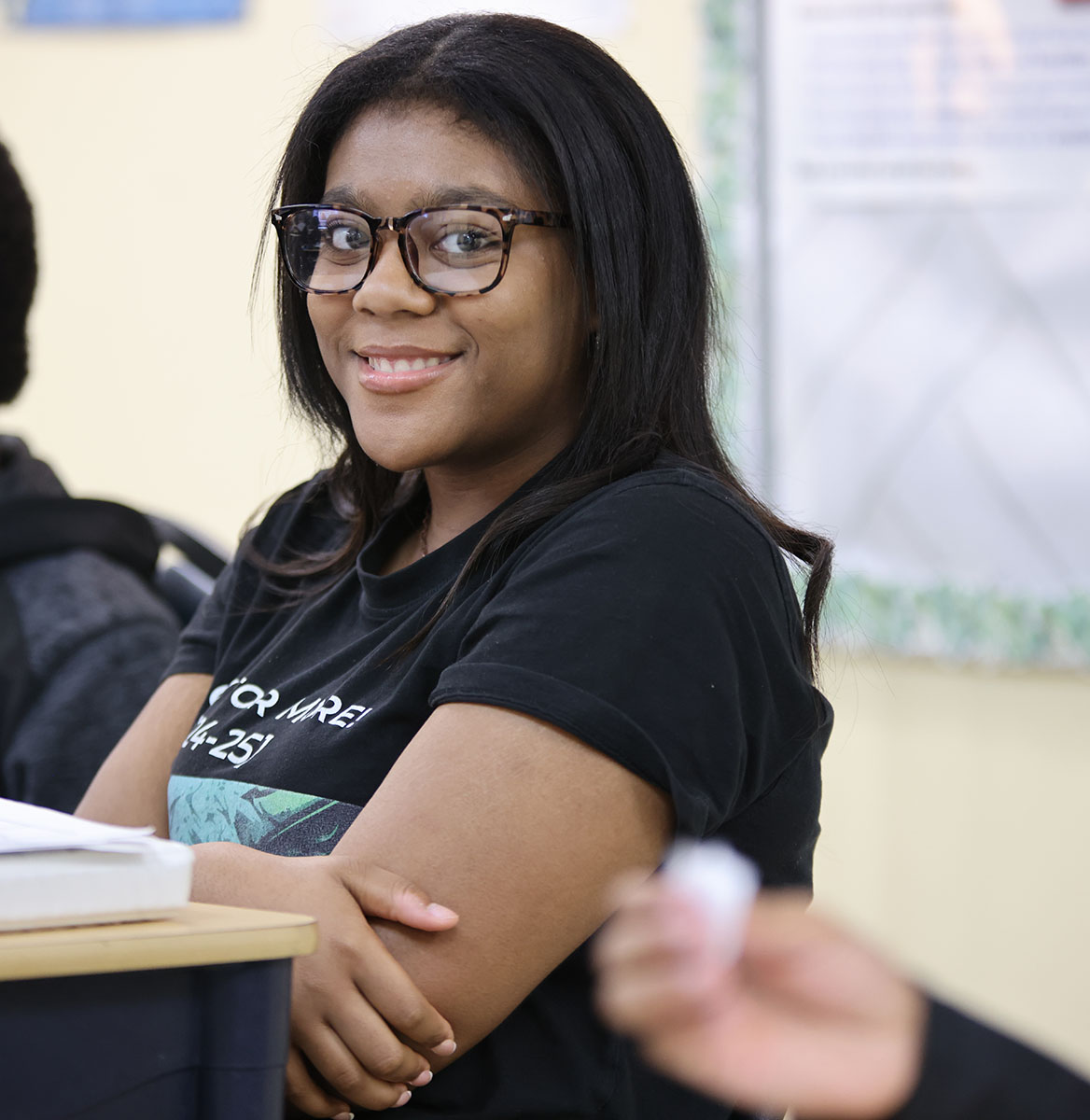 Student drawing in a classroom.